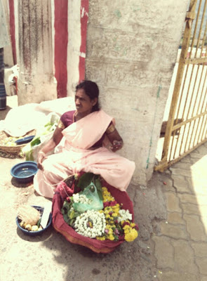 Spotted a lady selling flowers outside the temple premises.