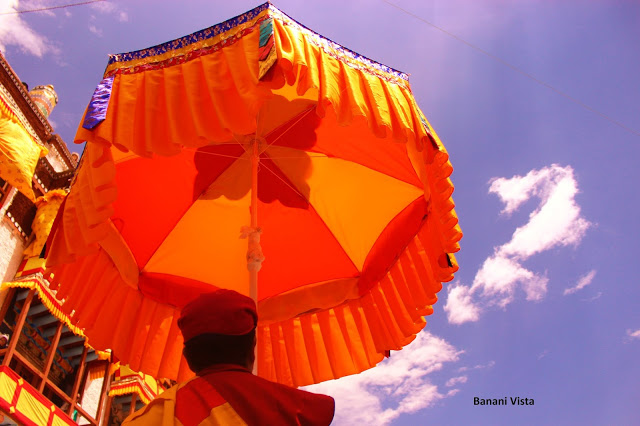 A man holding an umbrella for Guru Padmasambhava