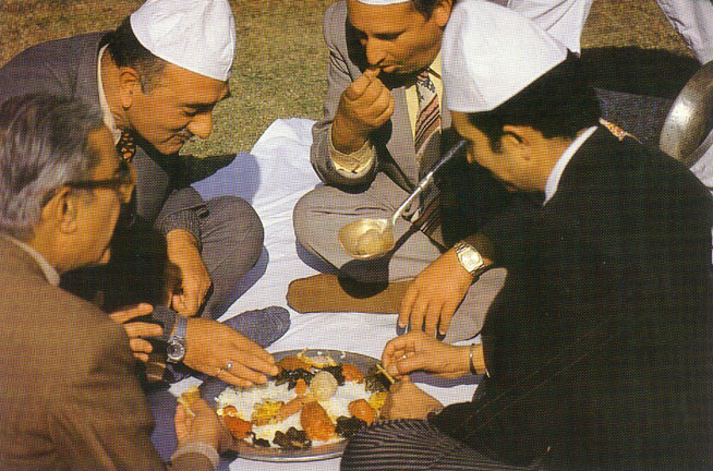 Four people having Wazwan in a Trammi