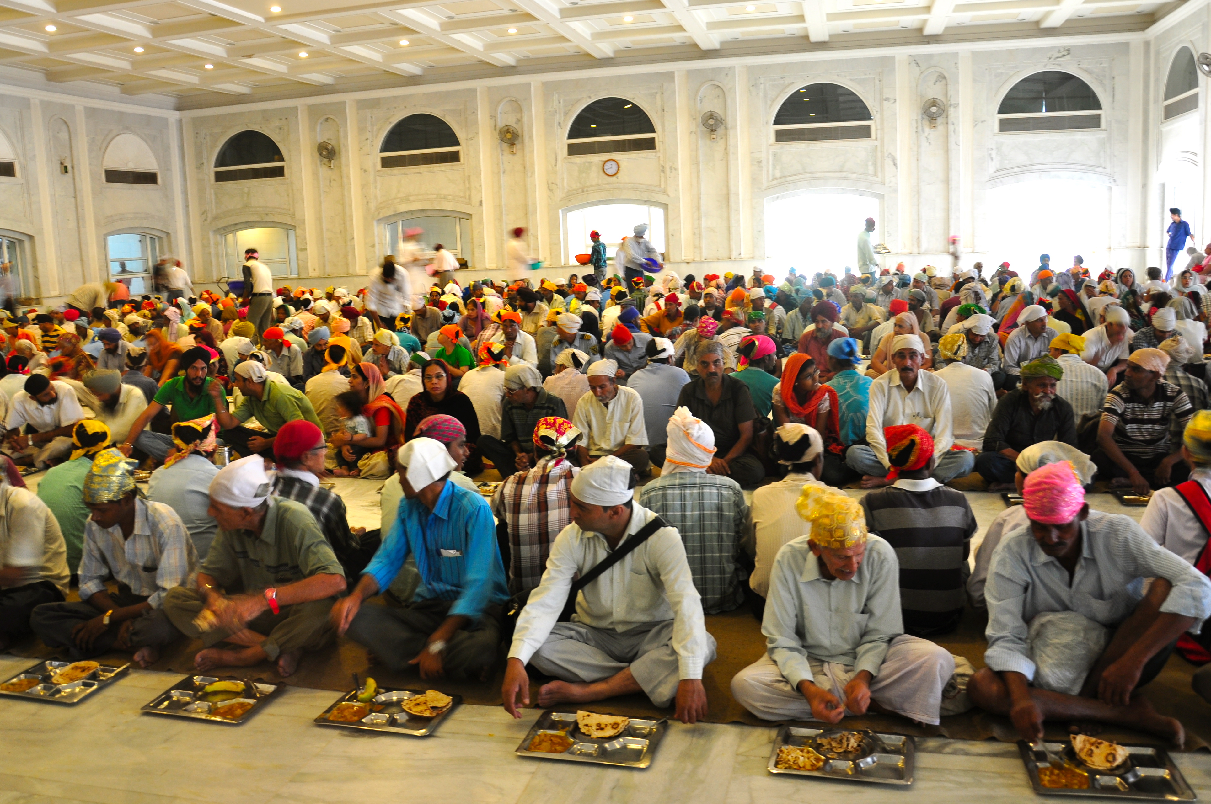 Thousands of individuals sitting together to have the ultimate Langar feast