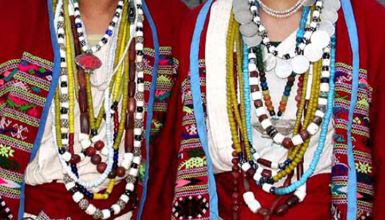 The outfits are brightly colored with tribal motifs
