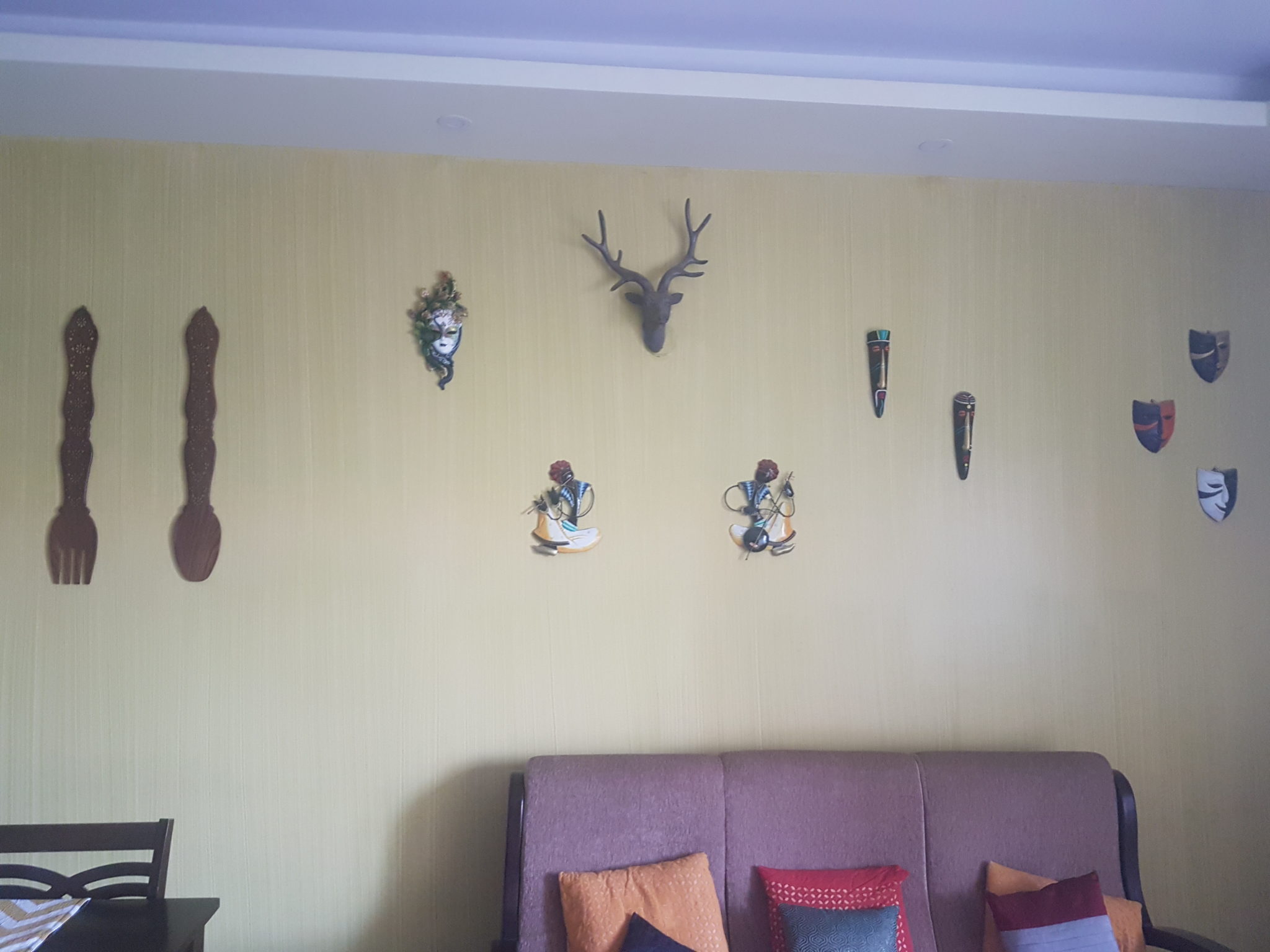 Mask themed wall in drawing room